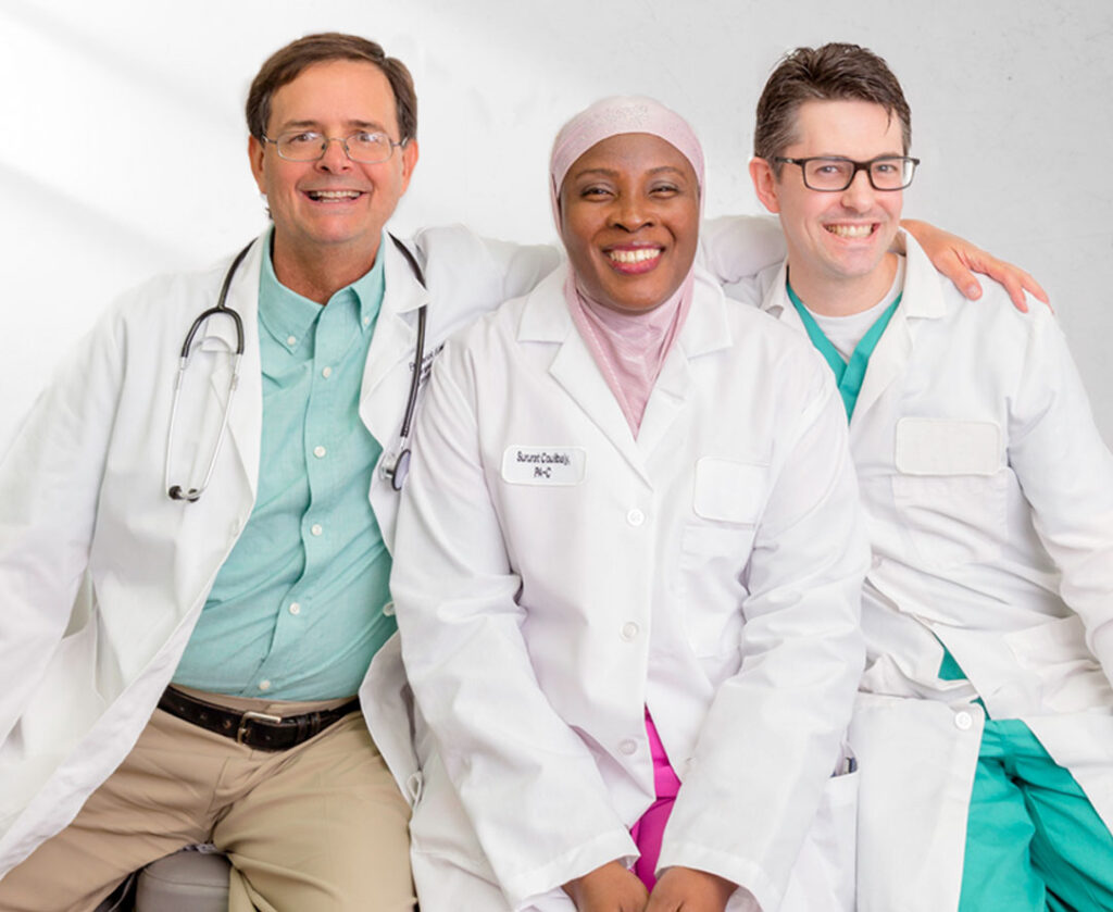 Three clinicians smiling